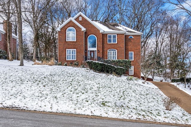 colonial inspired home with brick siding