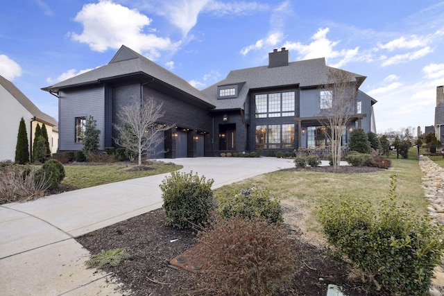 view of front of house featuring a garage and a front yard