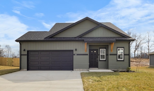 view of front of property featuring a garage and a front lawn