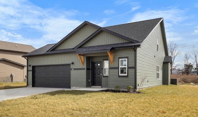 view of front facade featuring a garage, a front yard, and central air condition unit