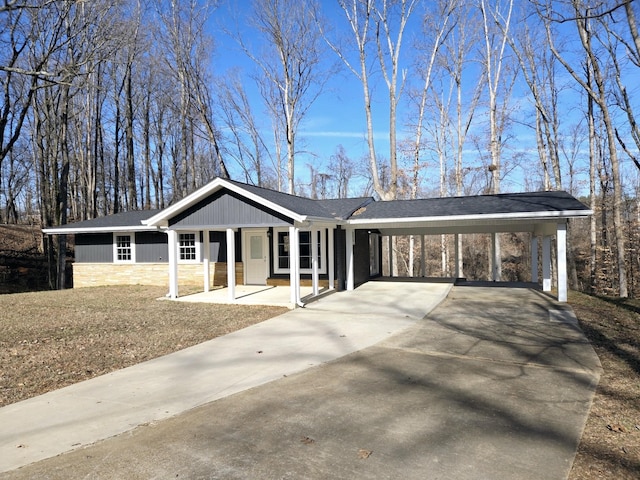 ranch-style house with a front yard, a carport, and a porch