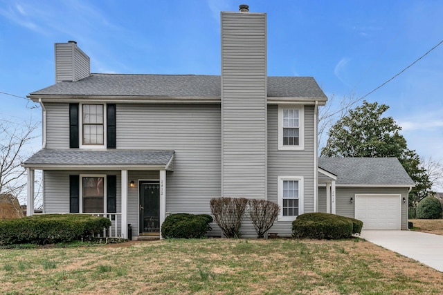 view of front of home featuring a garage, a front lawn, and covered porch