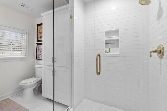 bathroom featuring walk in shower, tile patterned floors, and toilet