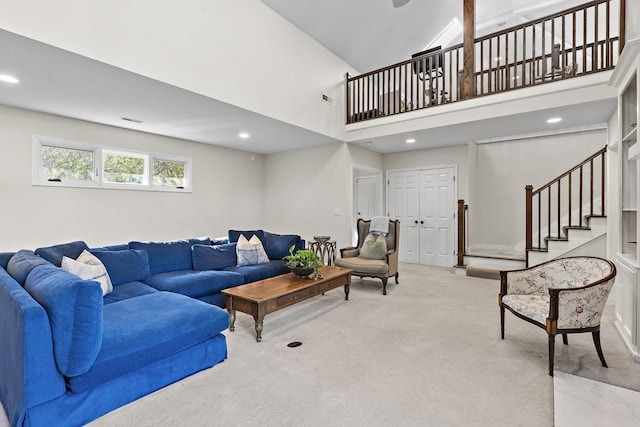 living room featuring light colored carpet and a high ceiling