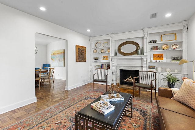 living room with parquet floors and built in features