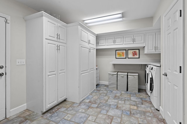 laundry area featuring cabinets and washing machine and clothes dryer