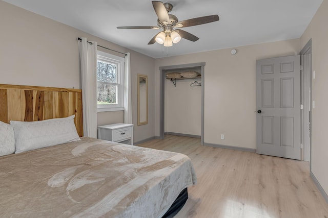 bedroom featuring ceiling fan, light wood-type flooring, and a closet