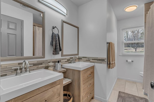 bathroom with tasteful backsplash, tile patterned floors, vanity, and toilet