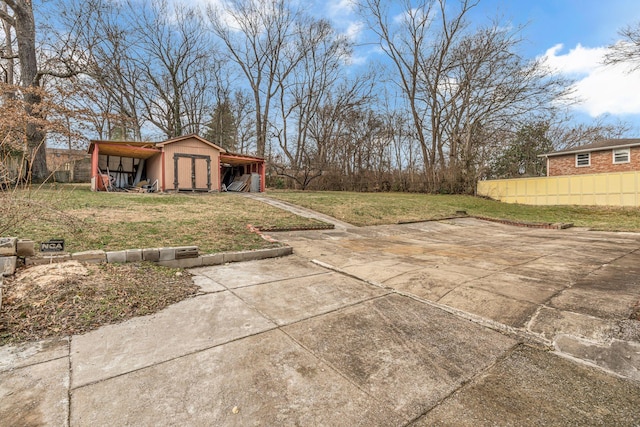 view of yard with a carport and a shed