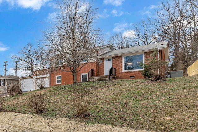 view of front of property featuring a garage and a front lawn