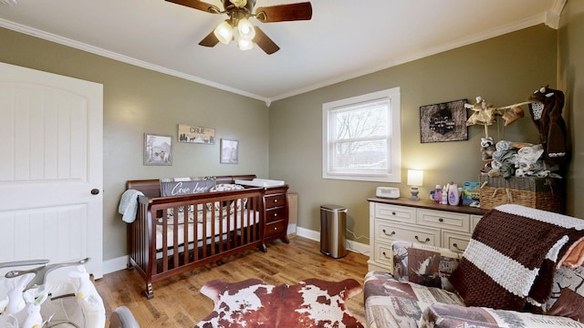 bedroom featuring light wood-type flooring, baseboards, and ornamental molding