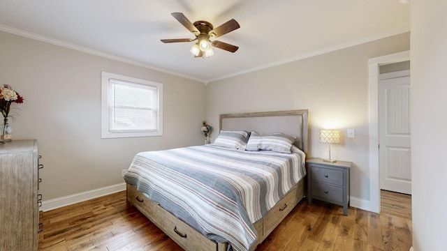 bedroom featuring ornamental molding, wood finished floors, a ceiling fan, and baseboards