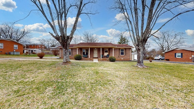 view of front of home with a porch, a front yard, and brick siding