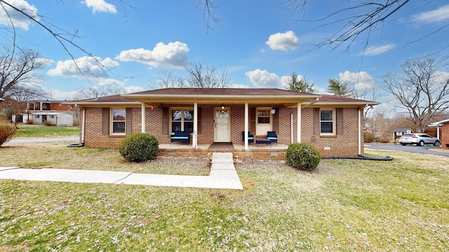 ranch-style home featuring brick siding, crawl space, a porch, and a front lawn