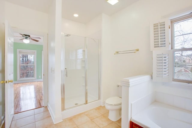 full bathroom featuring tile patterned floors, toilet, and a shower stall