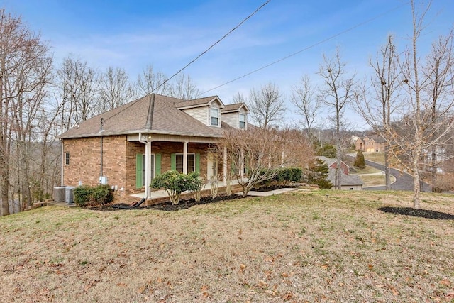 view of side of property with a yard and a porch