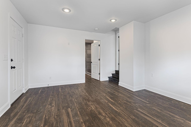 unfurnished room featuring dark wood-type flooring