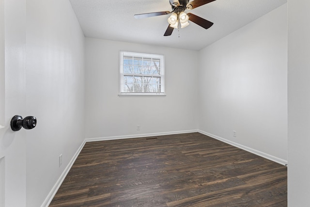 unfurnished room with dark wood-type flooring, ceiling fan, and a textured ceiling