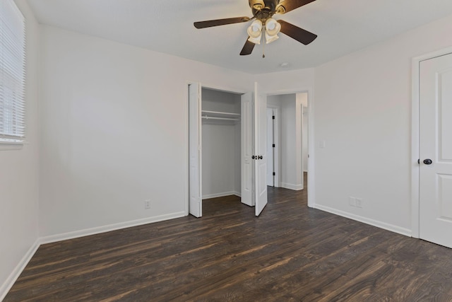 unfurnished bedroom with dark hardwood / wood-style floors, ceiling fan, and a closet