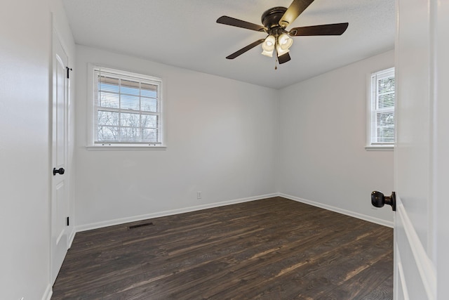 spare room featuring dark hardwood / wood-style floors and ceiling fan