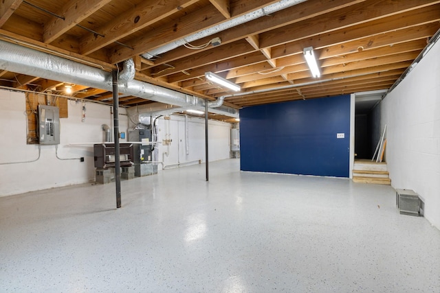 basement featuring gas water heater and electric panel