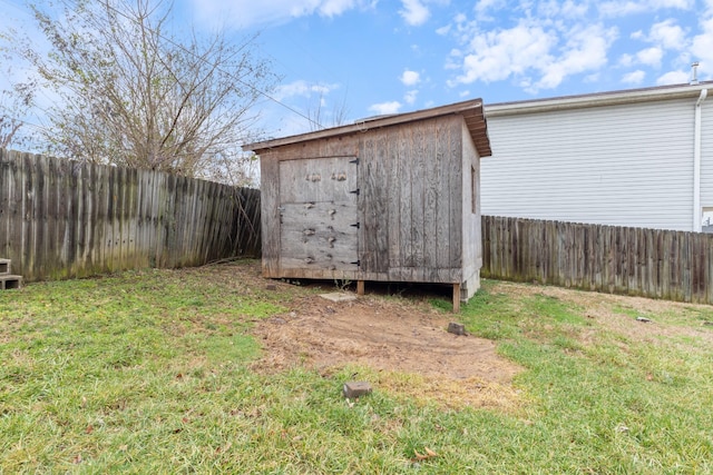 view of outbuilding featuring a lawn