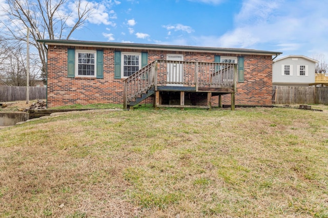 back of house with a lawn and a deck