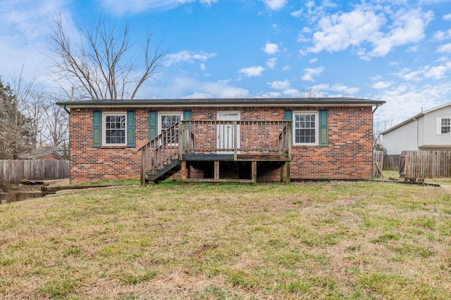 view of front facade with a deck and a front lawn