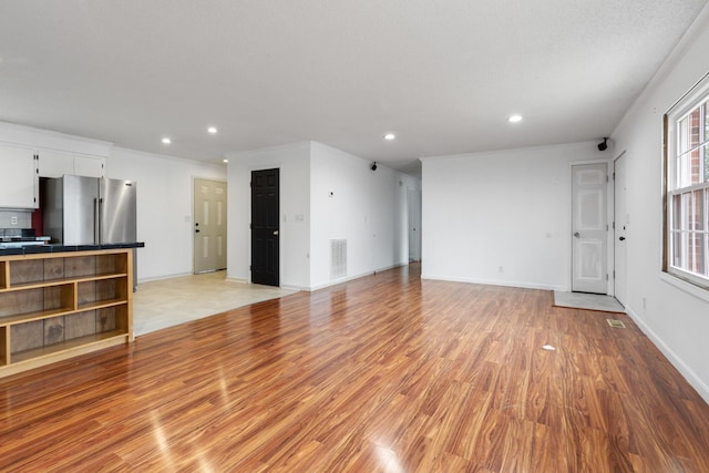 unfurnished living room featuring light hardwood / wood-style floors