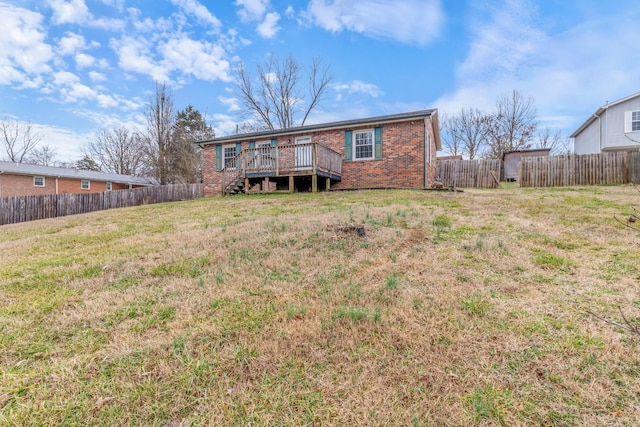 back of house with a wooden deck and a yard