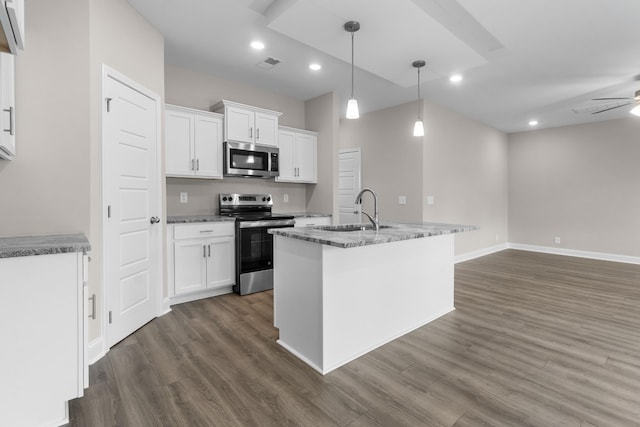 kitchen with sink, white cabinetry, hanging light fixtures, stainless steel appliances, and a center island with sink