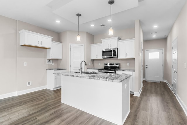 kitchen featuring light stone countertops, appliances with stainless steel finishes, sink, and white cabinets