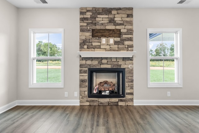 unfurnished living room featuring hardwood / wood-style flooring and a fireplace