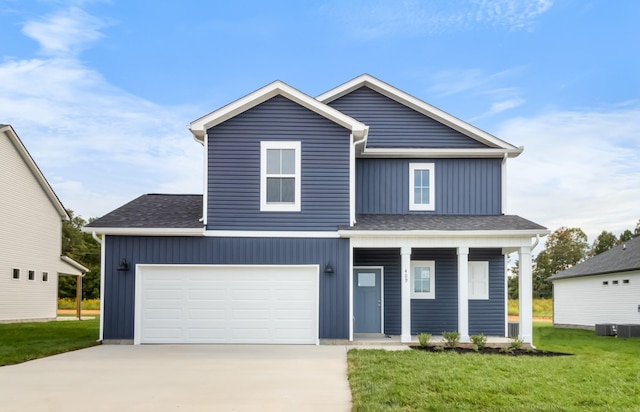 view of front facade featuring a garage, a front lawn, and a porch