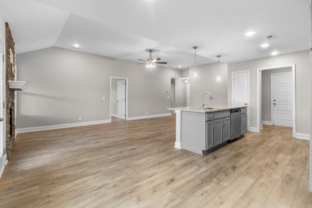 kitchen with a fireplace, decorative light fixtures, sink, gray cabinetry, and light wood-type flooring