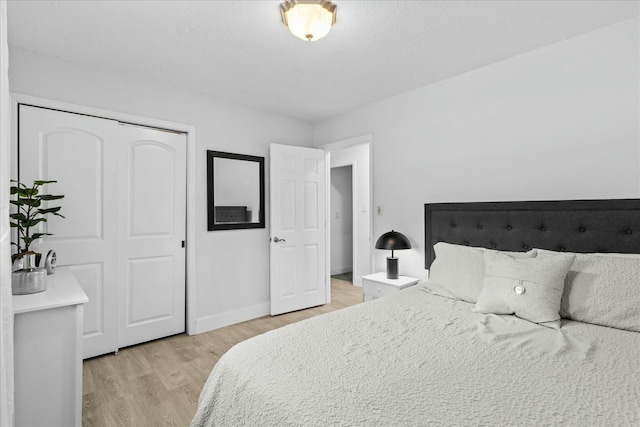 bedroom with a closet and light hardwood / wood-style flooring