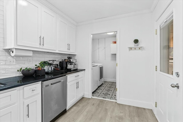 kitchen featuring light wood-type flooring, stainless steel dishwasher, white cabinets, washing machine and dryer, and backsplash