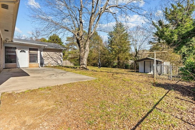 view of yard with a storage shed and a patio