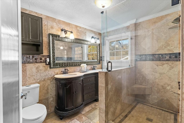 bathroom with crown molding, tile walls, a textured ceiling, vanity, and a shower with door