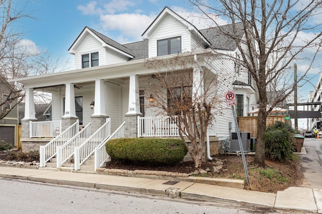 view of front of property with a porch and central AC