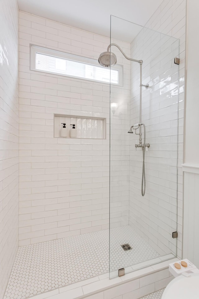 bathroom featuring toilet, plenty of natural light, and walk in shower