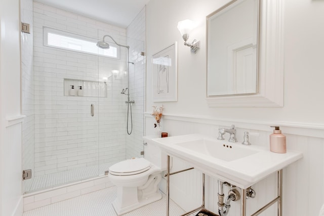 bathroom with tile patterned flooring, toilet, and walk in shower