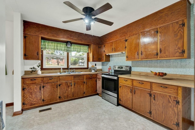 kitchen with sink, stainless steel electric range, ventilation hood, and ceiling fan