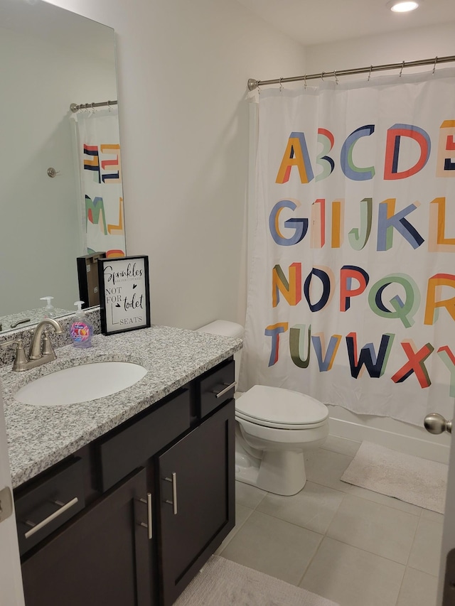 bathroom featuring a shower with curtain, vanity, toilet, and tile patterned flooring