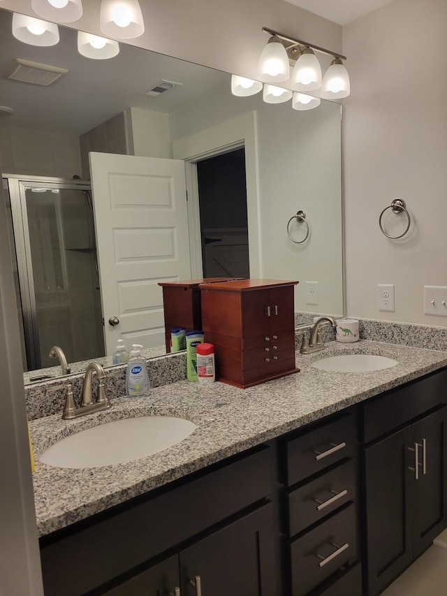 bathroom with walk in shower and vanity