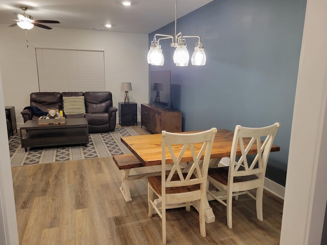 dining space with hardwood / wood-style flooring and ceiling fan