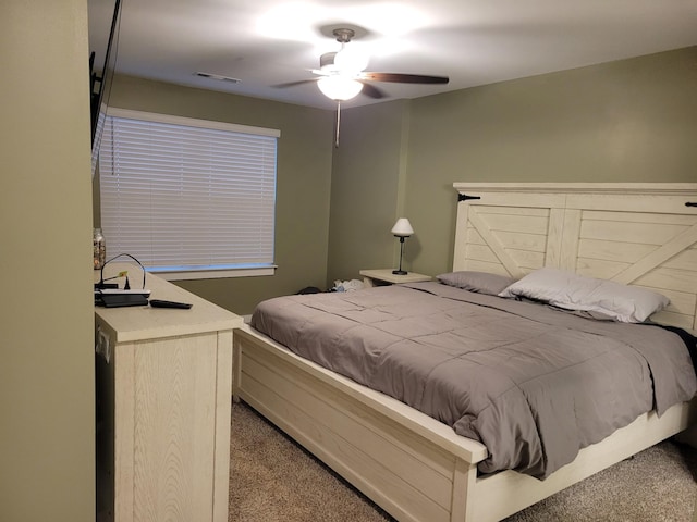 bedroom featuring light carpet and ceiling fan