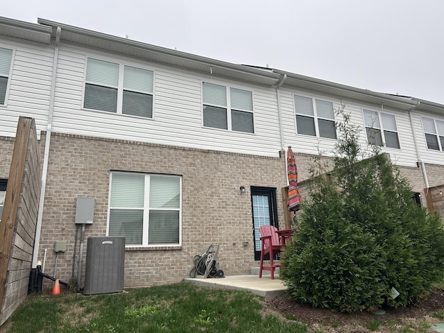 back of house with a patio and central AC unit