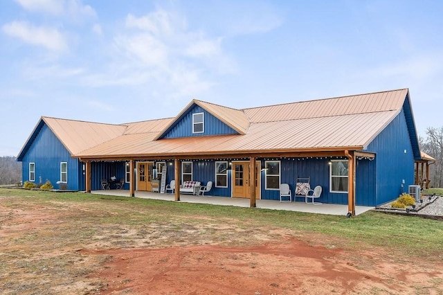 back of house with a patio, a yard, and central AC unit