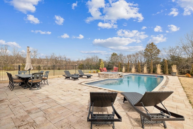 view of pool with an in ground hot tub and a patio area